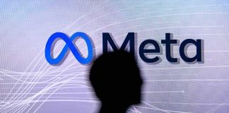 META Ordered to Pay $25 BILLION silhouette in front of Meta logo on screen