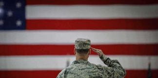 Why Invading America Would Be a NIGHTMARE Soldier saluting before a large American flag