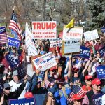 Rock Star IGNITES Crowd For Trump – WATCH THIS Tim Teufel, Christian Jones, and Nash the Slash among a crowd at a political rally holding signs and flags